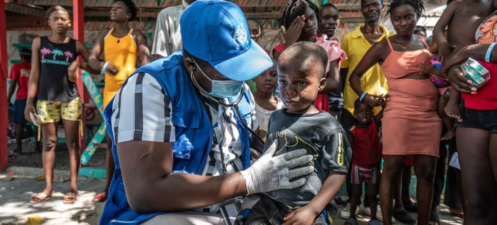 Local displaced and homeless Haitians gather for free medical treatment at an IOM mobile clinic in Place Clercine in Tabarre, Port-au-Prince.