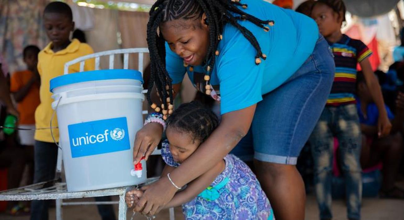 A mother and daughter attend a handwashing training session in Port-au-Prince, Haiti.